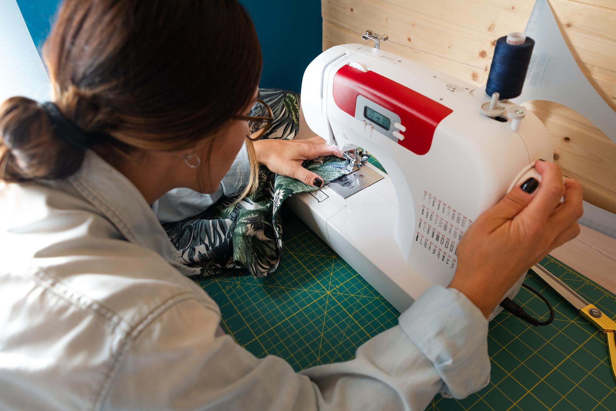 artisan at sewing machine finishing embroidered patch