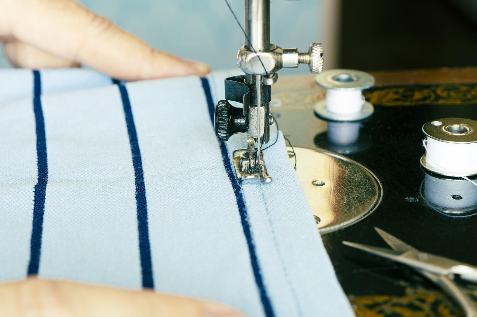 small scene: artisan trimming edge of finished patch