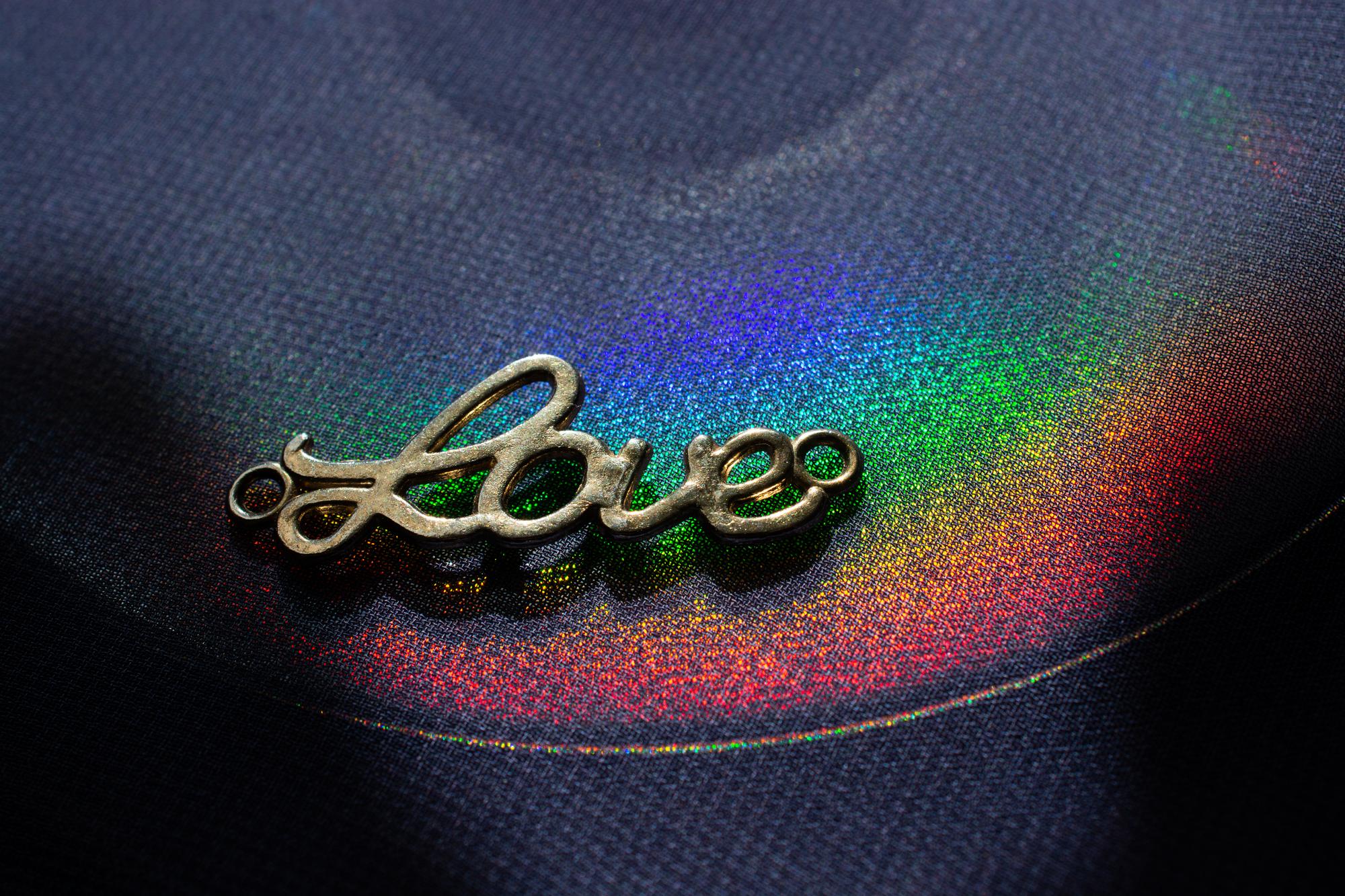 close-up of neon-thread embroidered emblem on black fabric